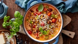 Pizza-Eintopf mit Hackfleisch, Mais und Paprika in einem gro&szlig;en Topf.