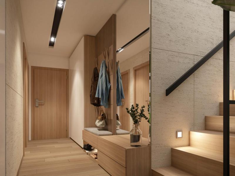 Luxuri&ouml;ser Hausflur mit einer Garderobe und einem Schrank und einer Treppe in Beiget&ouml;nen.